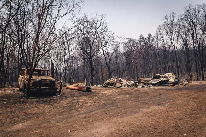A destroyed, burnt-out vehicle and house outside the town of Nymboida, New South Wales, in November 2019.