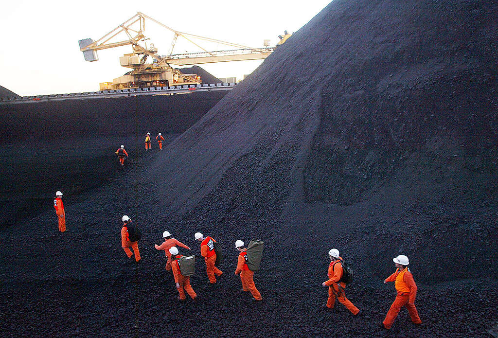 Greenpeace activists disrupt coal loading at the world's largest coal port. They highlight Australia's contribution to global climate change and to demand that Australia 'quit coal' and move to sustainable renewable energy.