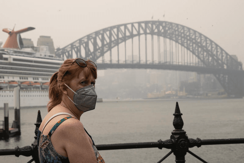 A woman wears a mask in Circular Quay in Sydney CBD  due to poor air quality index