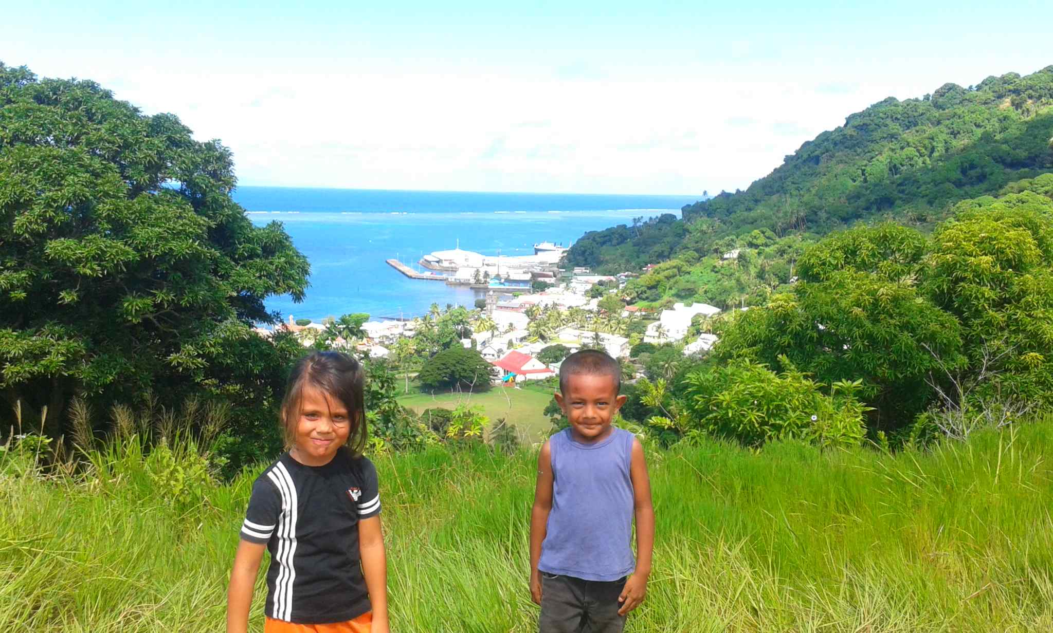 Young Pacific Islanders look out over the coastline