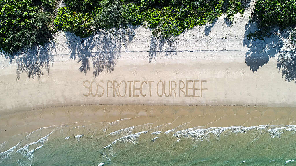 'SOS Protect Our Reef' Message on Beach near Cairns, Australia. © Greenpeace / Great Barrier Reef Legacy / Dean Miller