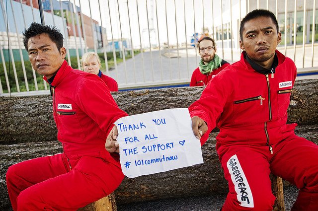 two activists sitting outside IOI refineries