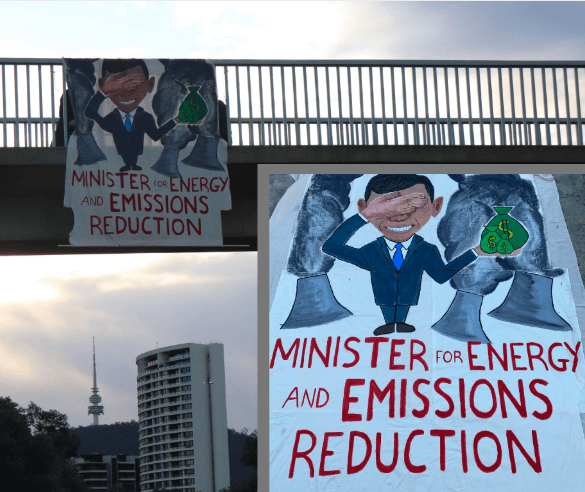 Banner showing Angus Taylor handing cash to coal hangs at motorway bridge in Canberra