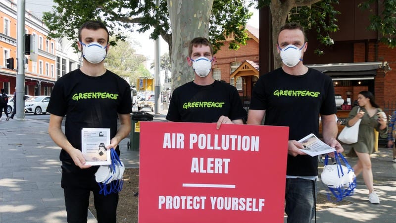 Greenpeace activists distributing P2 dust masks and safety guidelines flyers as Sydneysiders continue to choke under the effects of air pollution.