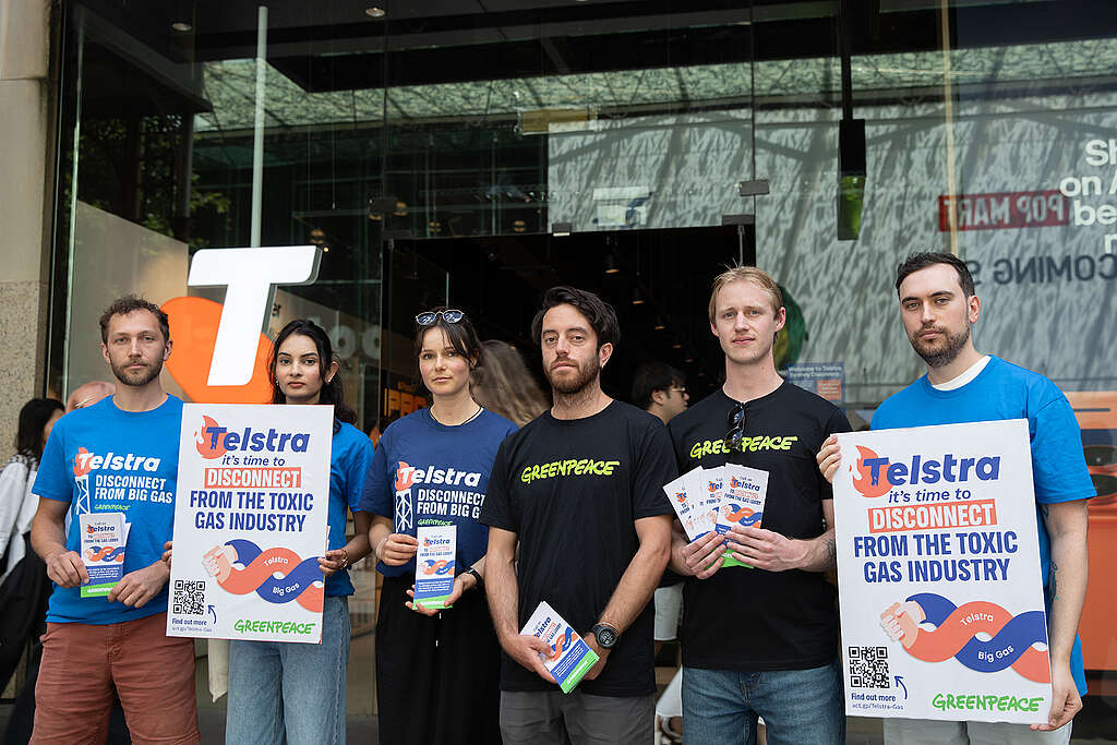 Activists hand out flyers to employees and customers outside Telstra's flagship store in Sydney. © Greenpeace
