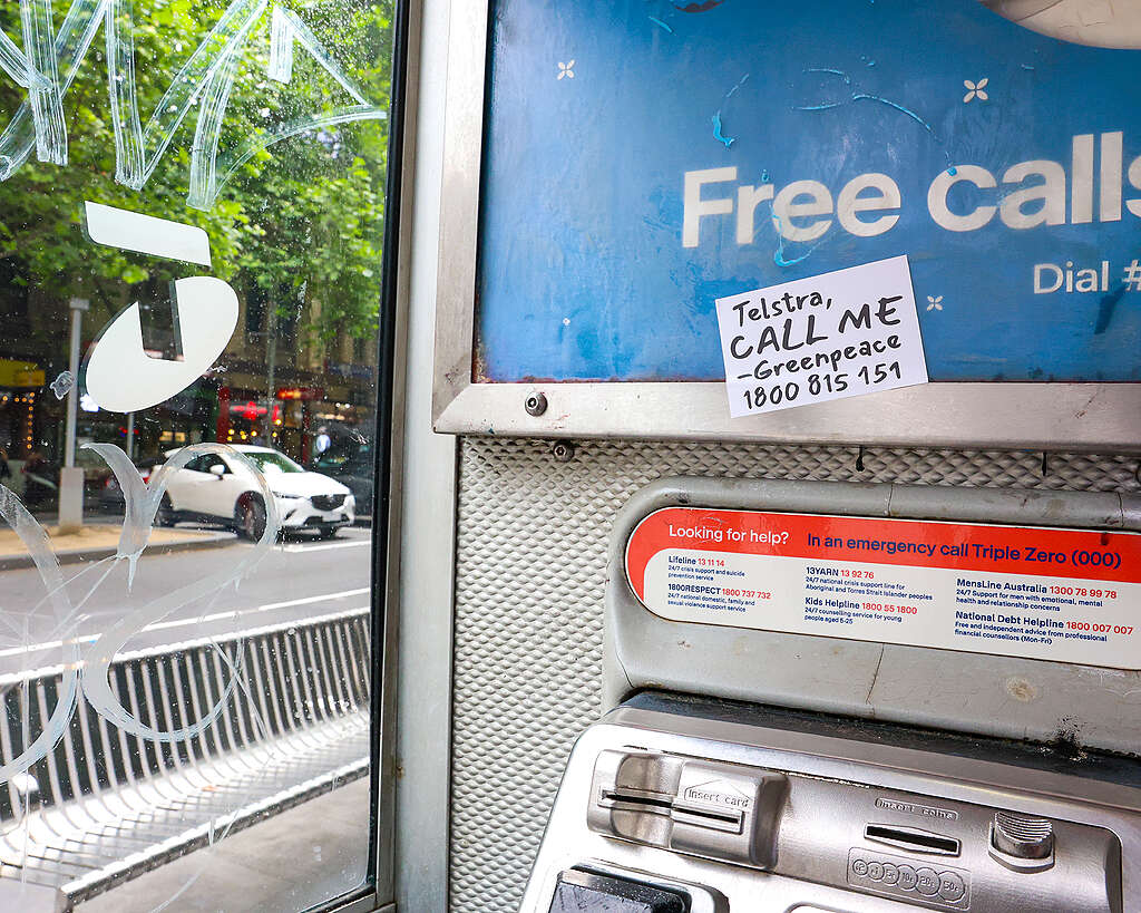 Call me, Telstra stickers appeared all over Telstra's phone booths across Melbourne and Sydney CBD. © Greenpeace