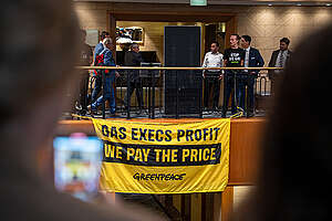 Greenpeace Australia Pacific activists disrupted the Australian Domestic Gas Outlook conference in Sydney. The banner reads &lsquo;Gas Execs Profit, We Pay The Price&rsquo;.